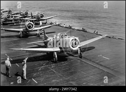 WW2 American dive bombers Douglas SBD-3 Dauntless from the 6th Bomb Squadron (Bombing Squadron 6, VB-6) are preparing to take off from the aircraft carrier USS Enterprise (CV-6) for raid on Wake Island. 1941  The second plane in the frame is the air group commander, Lieutenant Commander Howard Young. This is indicated by the designation GC (Group Commander) on the front of the engine casing. The Battle of Wake Island was a battle of the Pacific campaign of World War II, fought on Wake Island. Dates: 8 Dec 1941 – 23 Dec 1941 Stock Photo