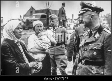 WW2 Reichsführer SS Heinrich Himmler talks to peasants during an inspection tour of Belarus. 1941 The Nazi-German state depicted the war against the Soviet Union as a racial war between German 'Aryans' and subhuman Slavs and Jews. From the very beginning the war against the Soviet Union included the brutal treatment of Soviet prisoners of war (POWs) by the Germans, in violation of every standard of warfare, and the killing of POWs on a massive scale. More than two million people were killed in Belarus during the three years of Nazi occupation, Stock Photo