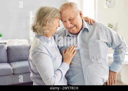 Happy Elderly Family Couple Embracing At Home Stock Photo