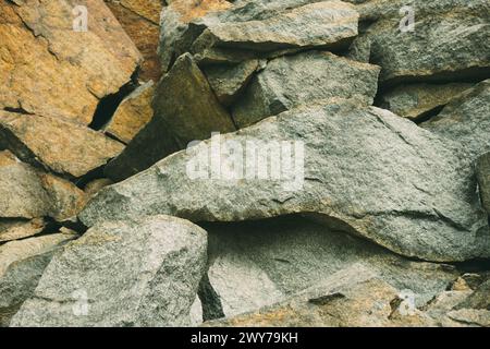 Large pile of stones. Stone rocks. Granite quarry. Abandoned industrial production. Stock Photo