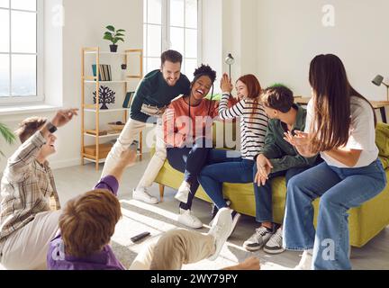 Young happy carefree people diverse group, graduate students, teens, college friends having fun  Stock Photo