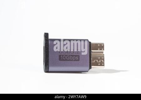 The image shows a dark grey USB 3.2 flash drive with a Type-C connector. The drive is isolated on a white background. Stock Photo