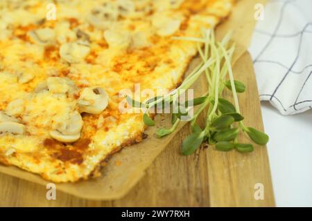 Close-up view of a plate with delicious vegetarian pizza and greens. The dish looks delicious and freshly prepared. Stock Photo