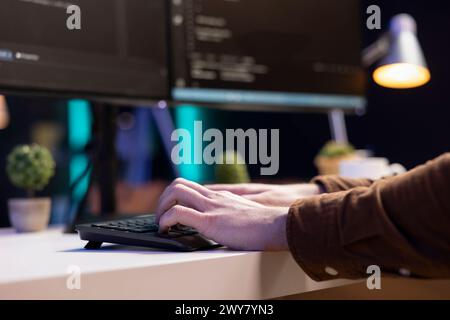 Teleworking system administrator futureproofing company network from downtimes and unexpected failures. Remote IT employee typing on keyboard, increasing data security, close up Stock Photo