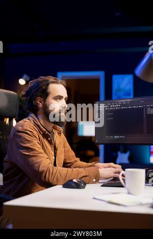 Cybersecurity professional using computer to look for company security vulnerabilities and dangerous malware. Programmer typing on keyboard, installing fortified code on PC to prevent cyber attacks Stock Photo