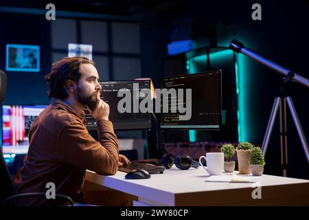 Programmer writing lines of code filtering malicious traffic from cybercriminals attempting to steal company data. Employee preventing hacking, malware, and phishing attacks Stock Photo