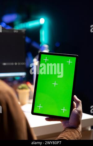 Cybersecurity expert using green screen tablet to secure company servers from virus attacks. IT remote employee writing code, building firewalls protecting data using mockup portable digital device Stock Photo