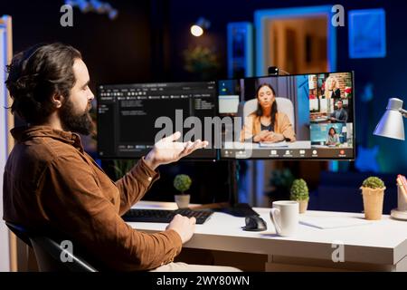 Computer science teacher doing online tutoring, telling students in online videocall about ways to fix computing bugs. IT professional teaching disciples in webinar how to do programming Stock Photo