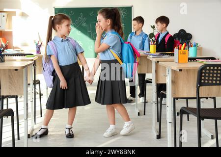 Cute little schoolgirls in classroom. School holidays concept Stock Photo