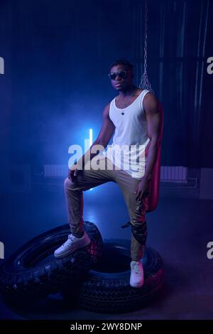 Fashion muscular rapper standing in neon lights of cool nightclub Stock ...