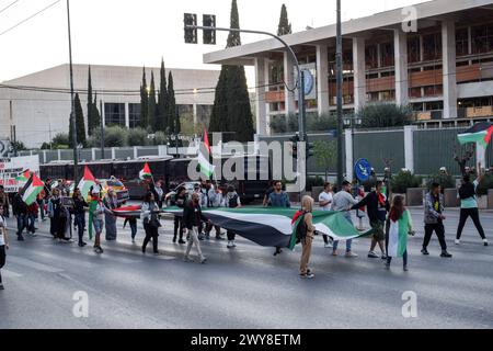Athens, Greece. 04 April 2024. Protesters march waving Palestinian flags and shouting slogans ahead of the US Embassy during a protest march against NATO. Foreign Ministers gathered today at NATO Headquarters in Brussels to mark the 75th anniversary since the signing of the Alliance's founding document, the North Atlantic Treaty. Credit: Dimitris Aspiotis/Alamy Live News Stock Photo