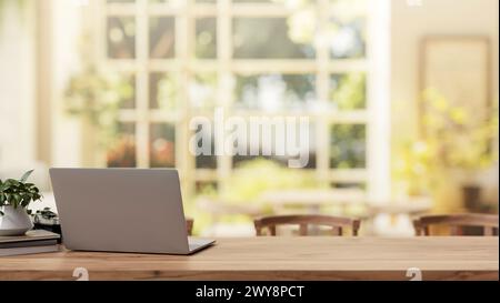 A laptop computer on a wooden table in a living room with a beautiful garden view on a sunny day. home workspace concept. 3d render, 3d illustration Stock Photo