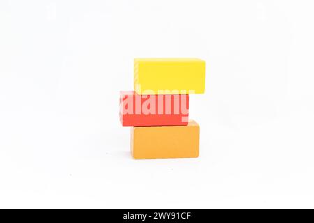 Stacked blank wooden toy blocks on a garden table outdoors against ...