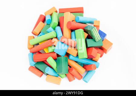 A pile of colorful wooden building blocks of different shapes and colors on isolated white background. Stock Photo