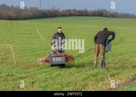 Shepherd and his daughter fence a new pasture with a solar panel for the electric fence, Mecklenburg-Western Pomerania, Germany Stock Photo