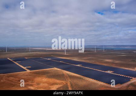 Aerial view of a renewable energy farm with wind turbines and solar panels in a vast open landscape Stock Photo