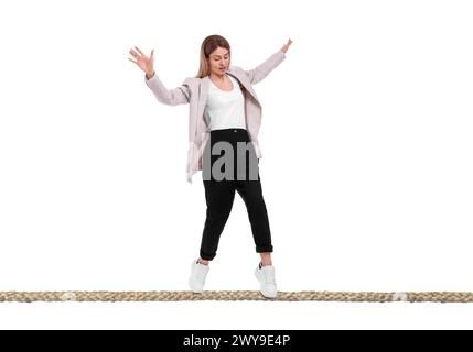 Businesswoman walking rope against white background. Risk or balance concept Stock Photo