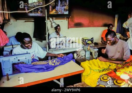 Senegal, Dakar, men work behind sewing machines in a sewing workshop. Stock Photo