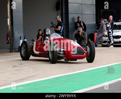 Julia De Baldanza driving an 1950, Alta F1 during the 75th Anniversary Demonstration of Grand Prix at Silverstone (Post '66 F1 Cars). Stock Photo