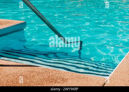 Steps leading into swimming pool in summer Stock Photo