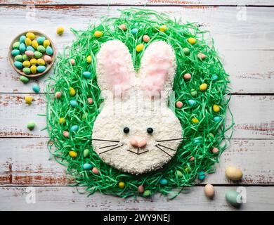 Top view of Easter bunny cake on white washed wood table. Stock Photo