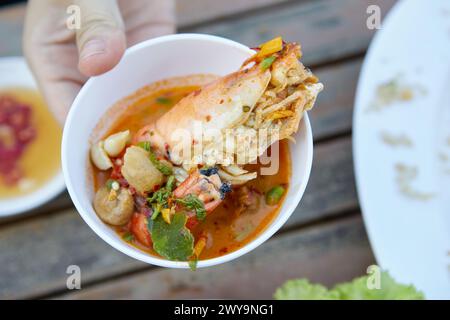 Spicy Tom Yum Goong and sour Thai food  in a bowl Stock Photo