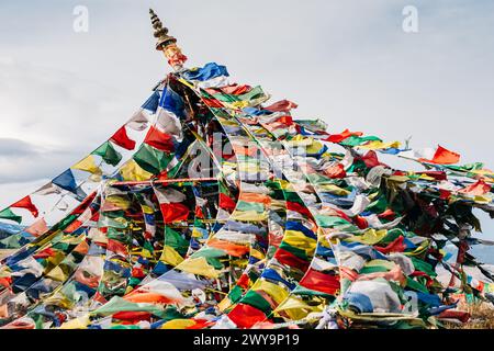 Colorful Buddhist prayer flags blowing in the wind Stock Photo
