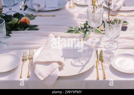 Sophisticated table setting with gold cutlery Stock Photo