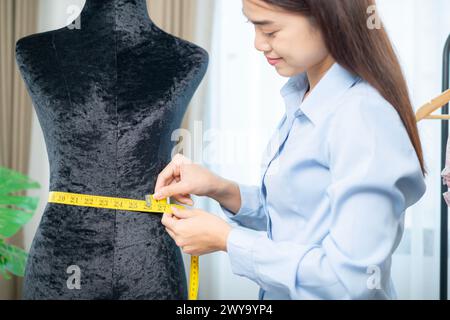 The young woman, owner of a clothing store business, is working at her own shop Stock Photo