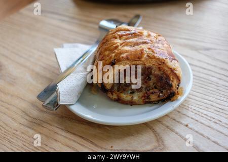 A Large sausage roll on a plate for lunch Loaf cafe Bristol Beacon UK Stock Photo