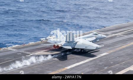 SOUTH CHINA SEA (March 27, 2024) An F/A-18F Super Hornet, assigned to the “Flying Checkmates” of Strike Fighter Squadron (VFA) 211, launches Stock Photo
