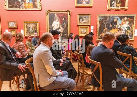 A wedding congregation of guests sitting during a wedding ceremony at Dulwich Picture Gallery in London, UK Stock Photo