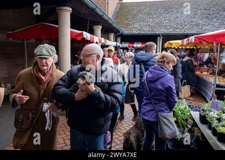 People and their dogs at Stroud Farmers Market on 30th March 2024 in Stroud, United Kingdom. Stroud is a market town and civil parish in Gloucestershire, known particularly for its thriving farmers market which takes place every Saturday, specialising in the best local produce. Stock Photo