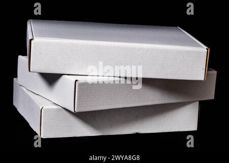 Three (3) white cardboard boxes stacked on top of each other Stock Photo