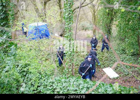 Police officers carry out searches at Kersal Dale, near Salford, Greater Manchester, where a major investigation has been launched after human remains were found on Thursday evening. Greater Manchester Police (GMP) said officers were called by a member of the public who found an 'unknown item wrapped in plastic'. Picture date: Friday April 5, 2024. Stock Photo