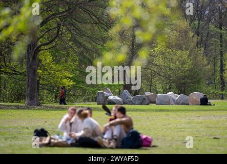 Berlin, Germany. 05th Apr, 2024. Young people sit on the lawn in the Tiergarten in the sunny weather. Credit: Monika Skolimowska/dpa/Alamy Live News Stock Photo
