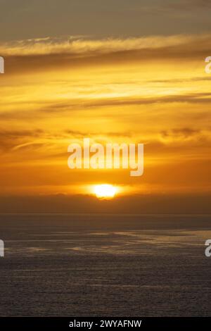 Orange sky with clouds on the ocean at sunset in Madeira island, Portugal Stock Photo