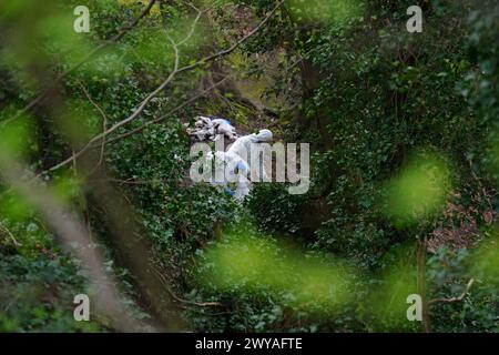 Police officers carry out searches at Kersal Dale, near Salford, Greater Manchester, where a major investigation has been launched after human remains were found on Thursday evening. Greater Manchester Police (GMP) said officers were called by a member of the public who found an 'unknown item wrapped in plastic'. Picture date: Friday April 5, 2024. Stock Photo