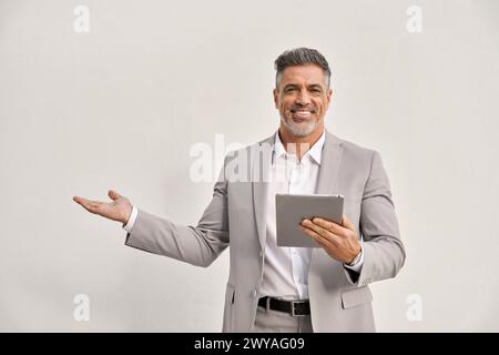 Happy middle aged business man using digital tablet isolated showing aside. Stock Photo