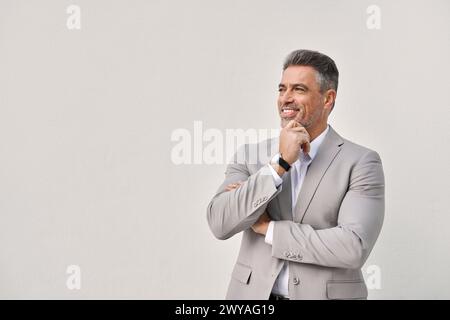Smiling mature businessman executive looking away isolated on white wall. Stock Photo