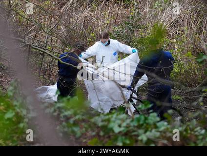 Police and forensic officers at Kersal Dale, near Salford, Greater Manchester, where a major investigation has been launched after human remains were found on Thursday evening. Greater Manchester Police (GMP) said officers were called by a member of the public who found an 'unknown item wrapped in plastic'. Picture date: Friday April 5, 2024. Stock Photo