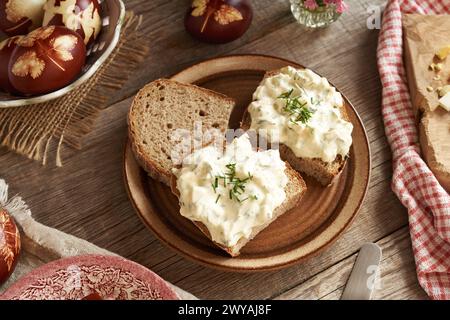 Slices of sourdough bread with spread made of Easter eggs dyed with onion peels Stock Photo