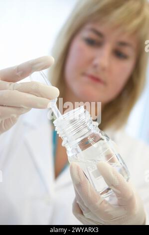 Technical staff taking samples of chemical solution. Laboratory, Fundación Inbiomed, Genetrix Group. Center for research in stem cells and regenerative medicine. Donostia, San Sebastian, Euskadi. Spain. Stock Photo
