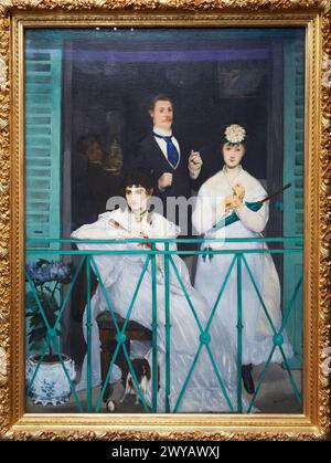 'The Balcony' 1868. Edouard Manet. 1832 - 1883. Berthe Morisot, the violinist Fanny Claus, and behind the women is the painter Antonin Guillemet. Musée d'Orsay. Orsay Museum. Paris. France. Stock Photo