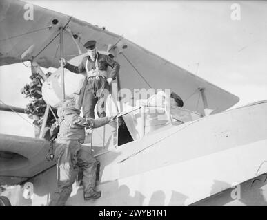 ON BOARD THE AIRCRAFT CARRIER HMS ARGUS. 1940. - Signalman watching for patrolling aircraft from the signal deck of the ARGUS. He reports 'aircraft behind the clouds, sir'. , Stock Photo