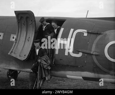 BRITISH NAVY ENTERS BERLIN. 12 AND 13 JULY 1945, BERLIN. ROYAL NAVY AND MARINE DETACHMENTS WHO TOOK PART IN THE CEREMONIAL MARCH THROUGH BERLIN. - Some of the men leaving one of the planes at Gatow airport, Berlin. They had been flown from Hamburg. , Stock Photo