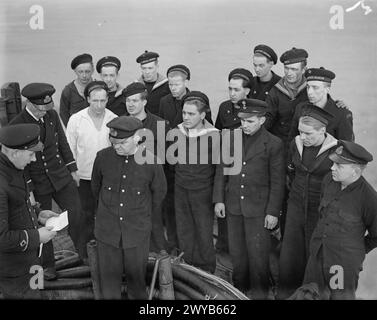 The captain of Norwegian minesweeper HNMS Alcmaria reads a message from ...