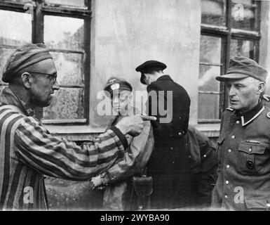 THE HOLOCAUST, 1941-1945 - A liberated Russian slave worker points out a Nazi guard who beat prisoners at a concentration camp entered by troops of the 3rd Armoured Division, First US Army, 1945. , Stock Photo
