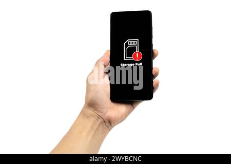 Cellular Problems Concepts. Man hand holding smart phone with full storage icon on screen isolated on white background. All screen graphics are made u Stock Photo