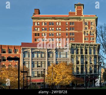 view of downtown Binghamton buildings at sunset golden hour (historic architecture including the press building on court street and chenango) autumn c Stock Photo
